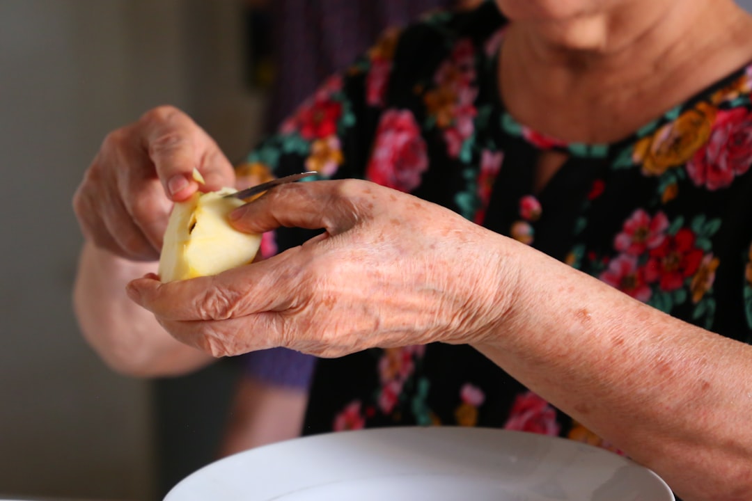 A carer assisting an older person with a warm smile